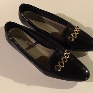 Low heeled black patent leather slip on shoes